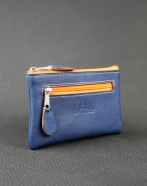 Porte monnaie en cuir bleu marine avec deux poches doublées en tissus africain et zip orange